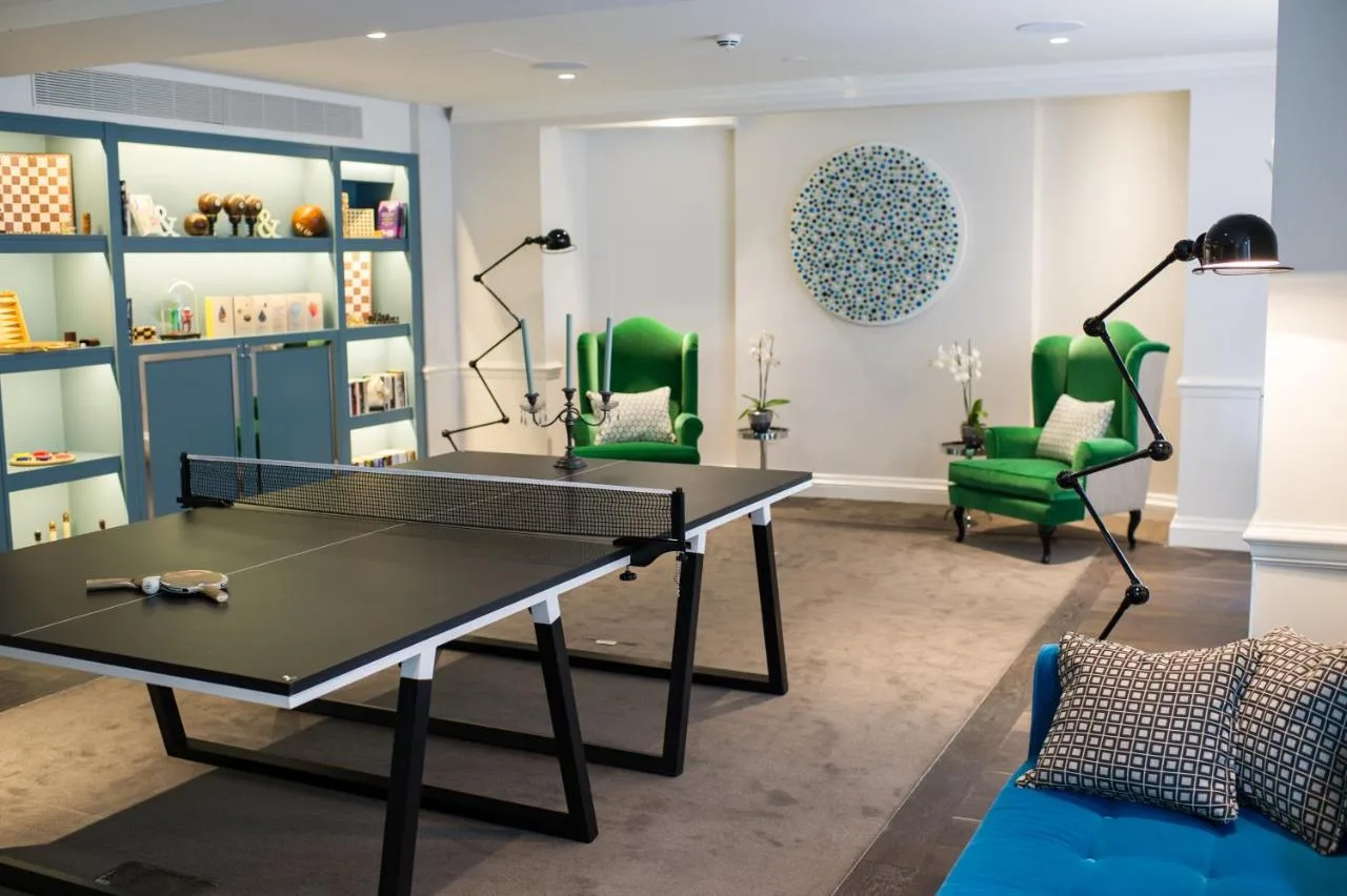 Games room with ping pong table and armchairs at The Ampersand Hotel