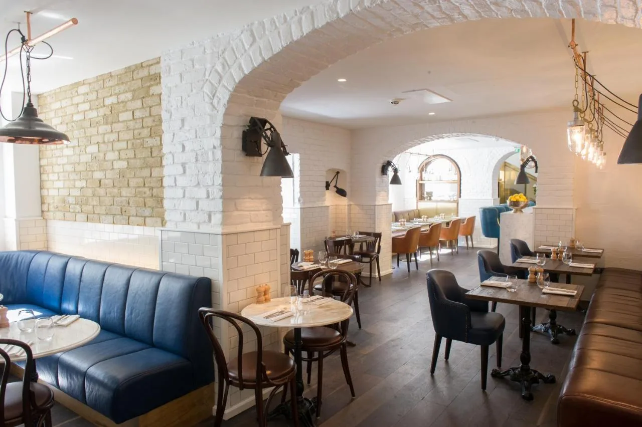 Lounge with blue sofa and tables at The Ampersand Hotel