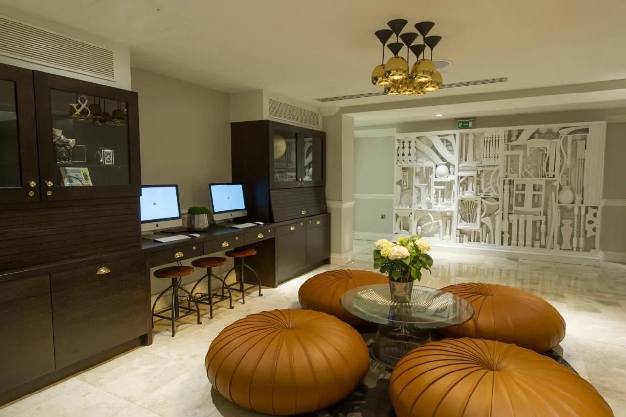 Living room with table and stools at The Ampersand Hotel
